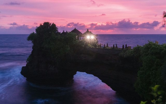 Sunset over a sea temple in Bali